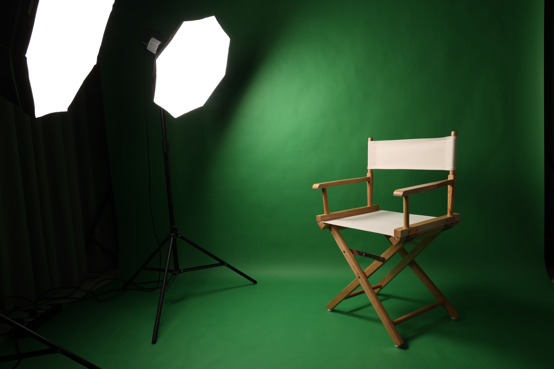 Chair of Film Director. Directors chair in green screen studio setup with softbox lighting. Ideal for filmmaking video production photo interviews and creative content with green chroma key background
